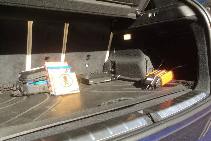 A Sony Blu-ray player in the trunk of a BMW X1